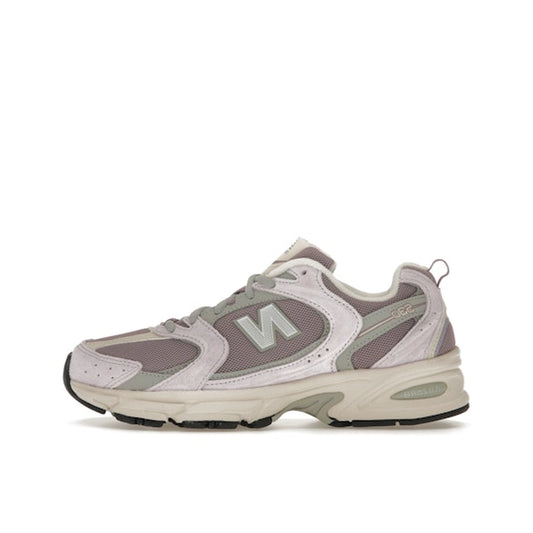 New Balance 530 sneakers, side view, in lilac and viola with white and silver details.