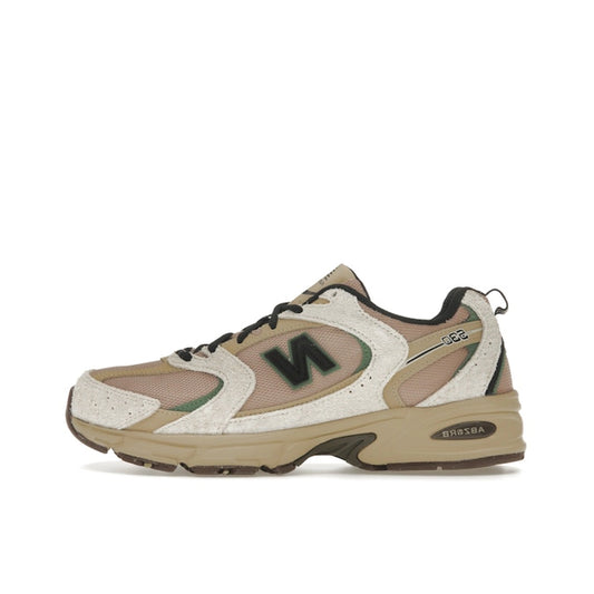 New Balance 530, side view, in linen and incense tones with mesh and suede overlays.