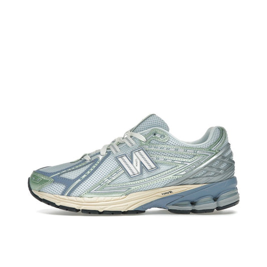 New Balance 1906R U1906RNE, side view, in pastel ice blue with vibrant melon overlays.