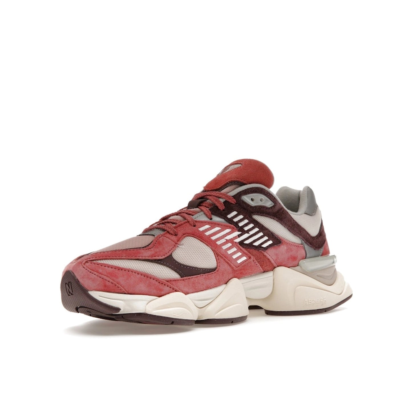 New Balance 9060 sneakers, front view, model U9060TRU in cherry blossom with beige and white details.