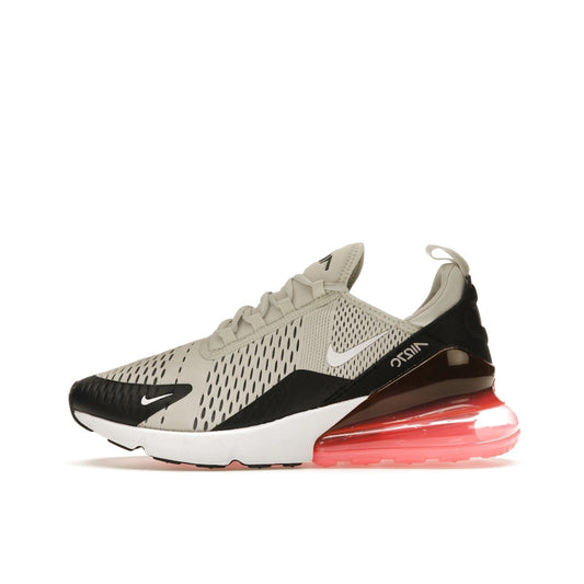 Nike Air Max 270, side view, in light bone tones and bold hot punch heel bubble.