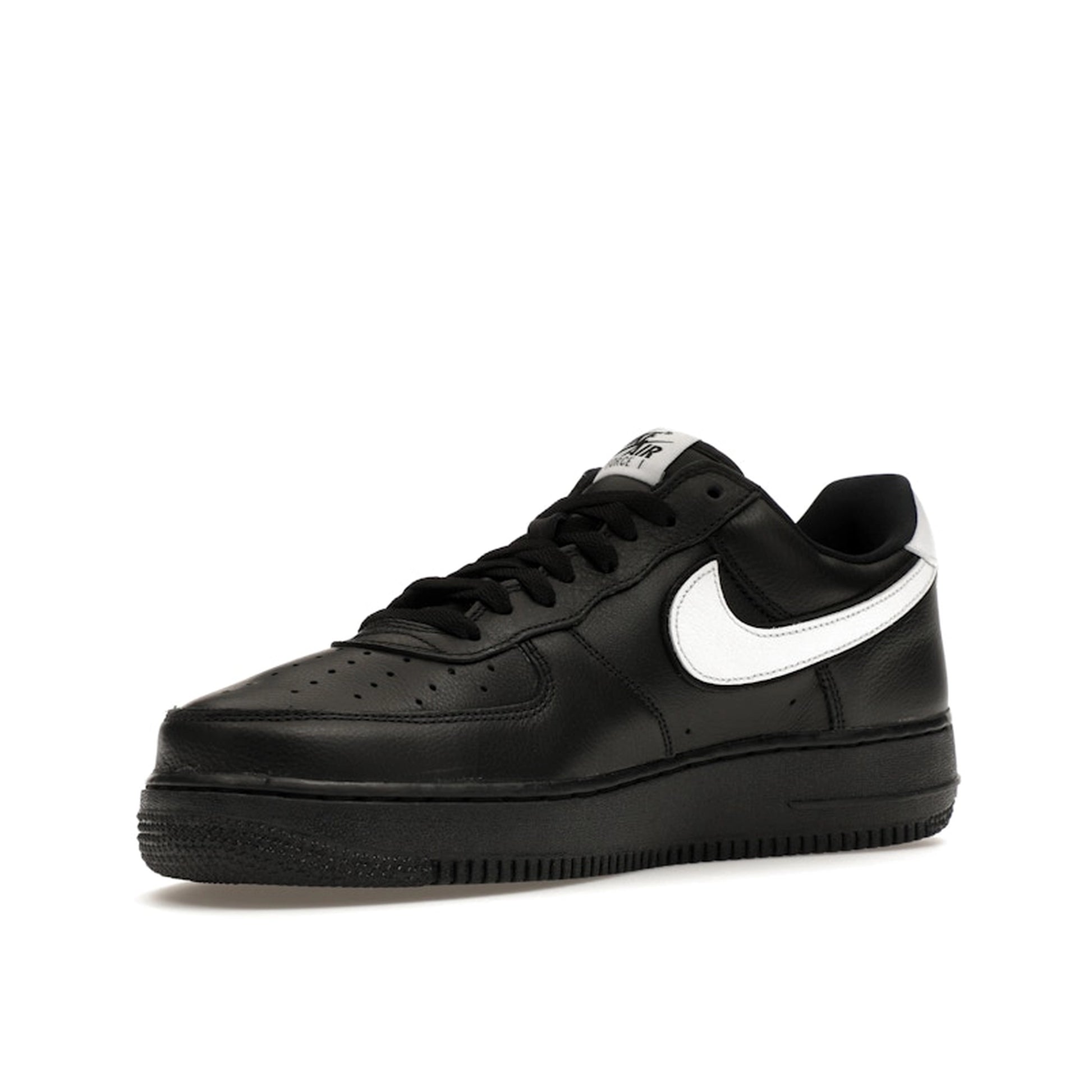 Nike Air Force 1 Low QS sneakers, front view, model CQ0492-001 in black with white details.