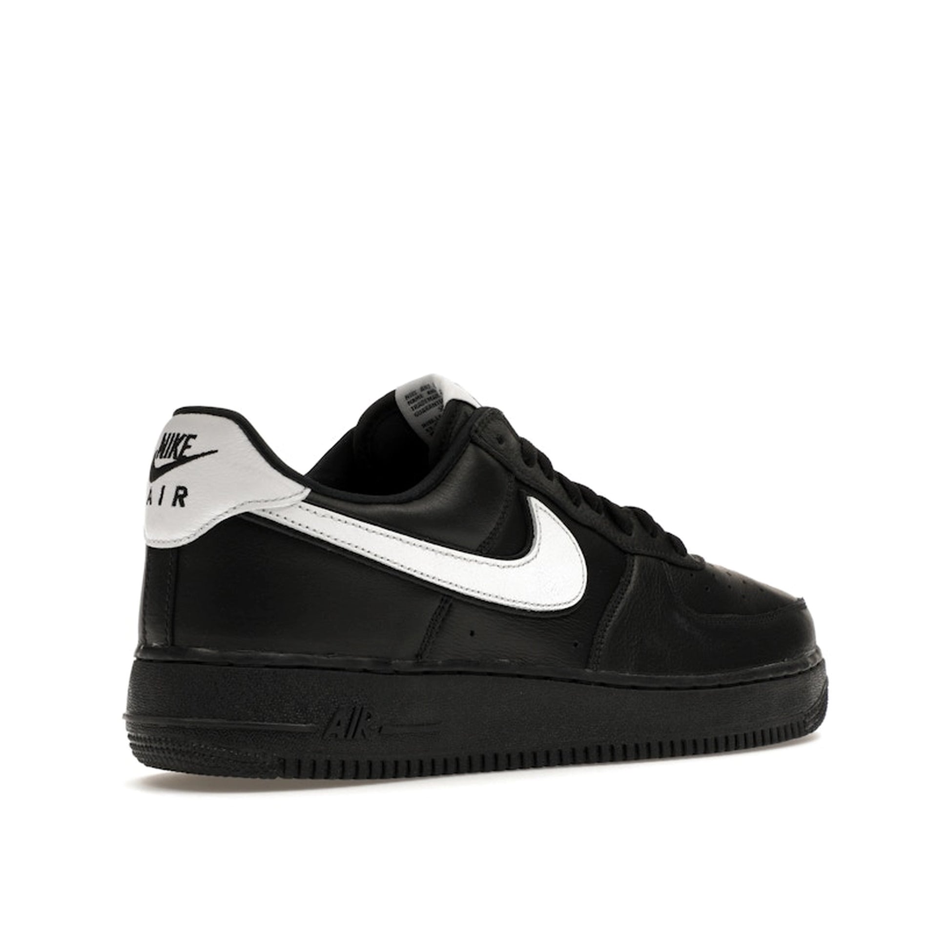 Nike Air Force 1 Low QS sneakers, back view, model CQ0492-001 in black with white details.