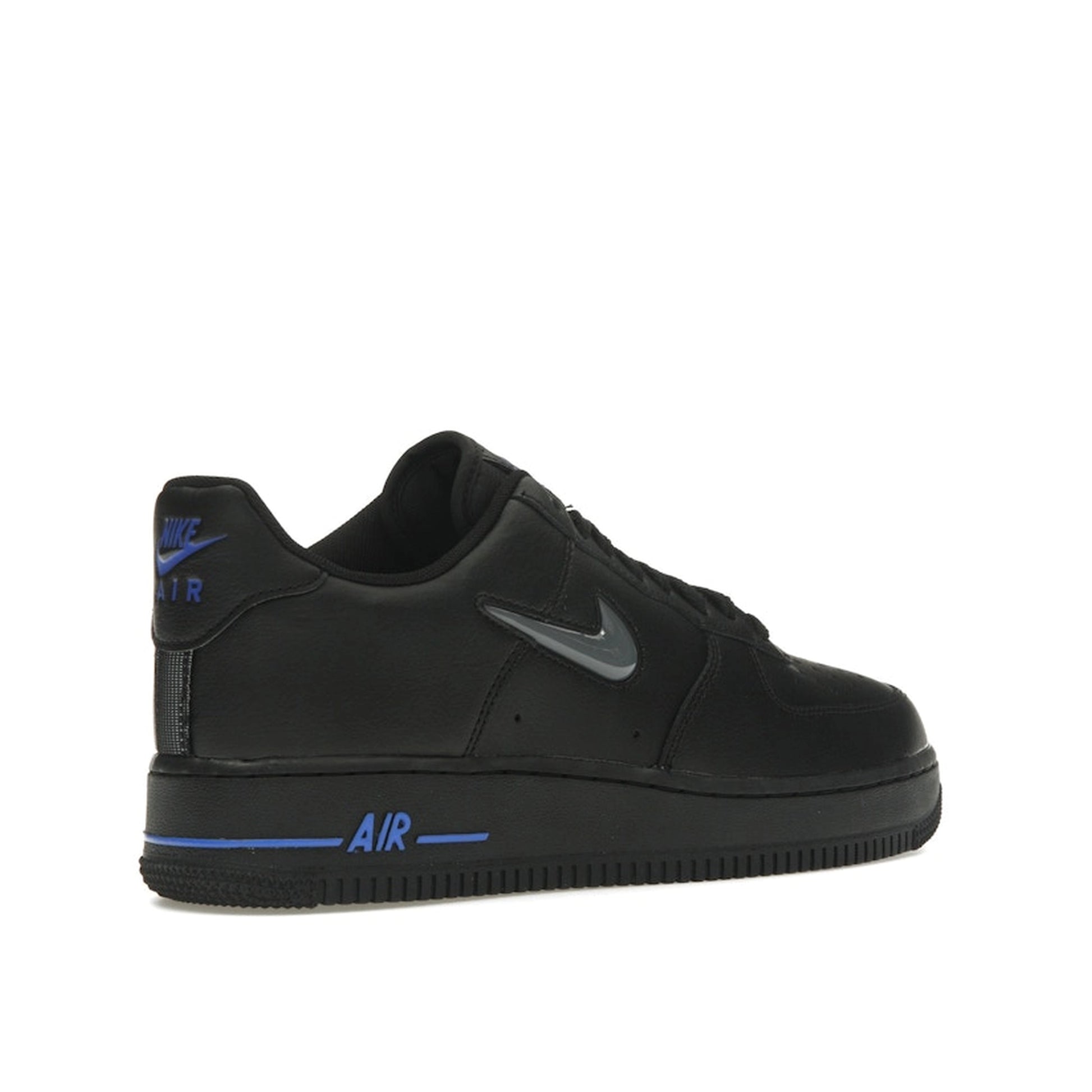 Nike Air Force 1 Low sneakers, back view, in black with jewel swoosh in grey and royal blue.