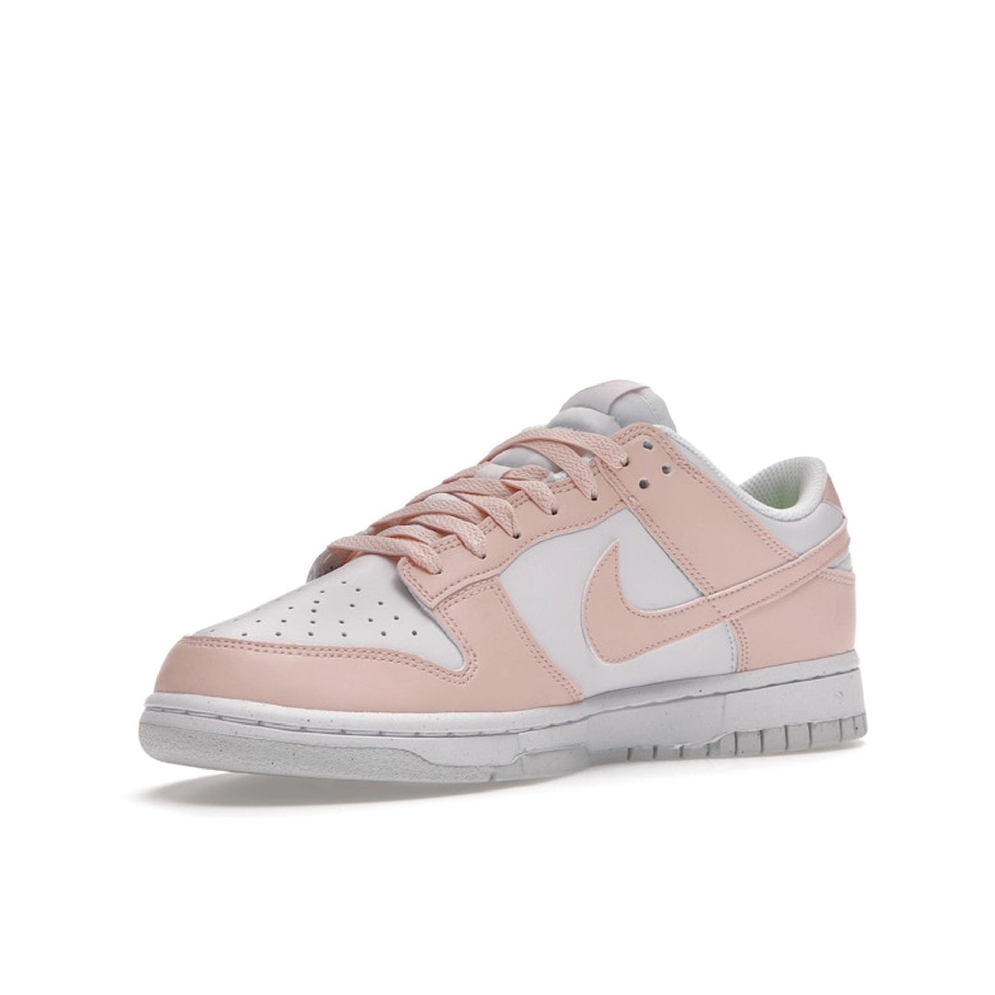 Nike Dunk Low Next Nature Women’s sneakers, front view, in pale coral and white.