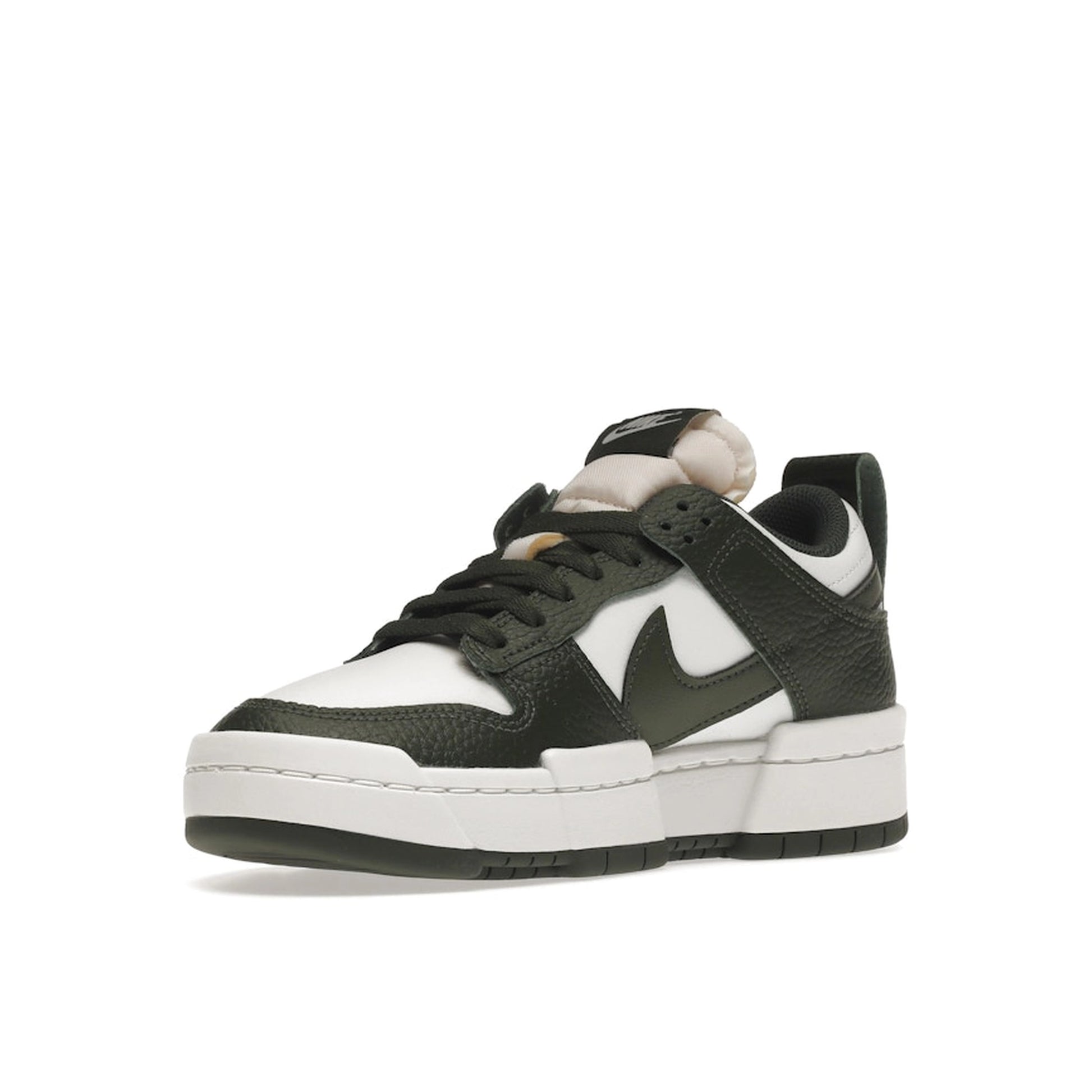 Nike Dunk Low Disrupt, front view, in forest green overlays with clean white leather panels.