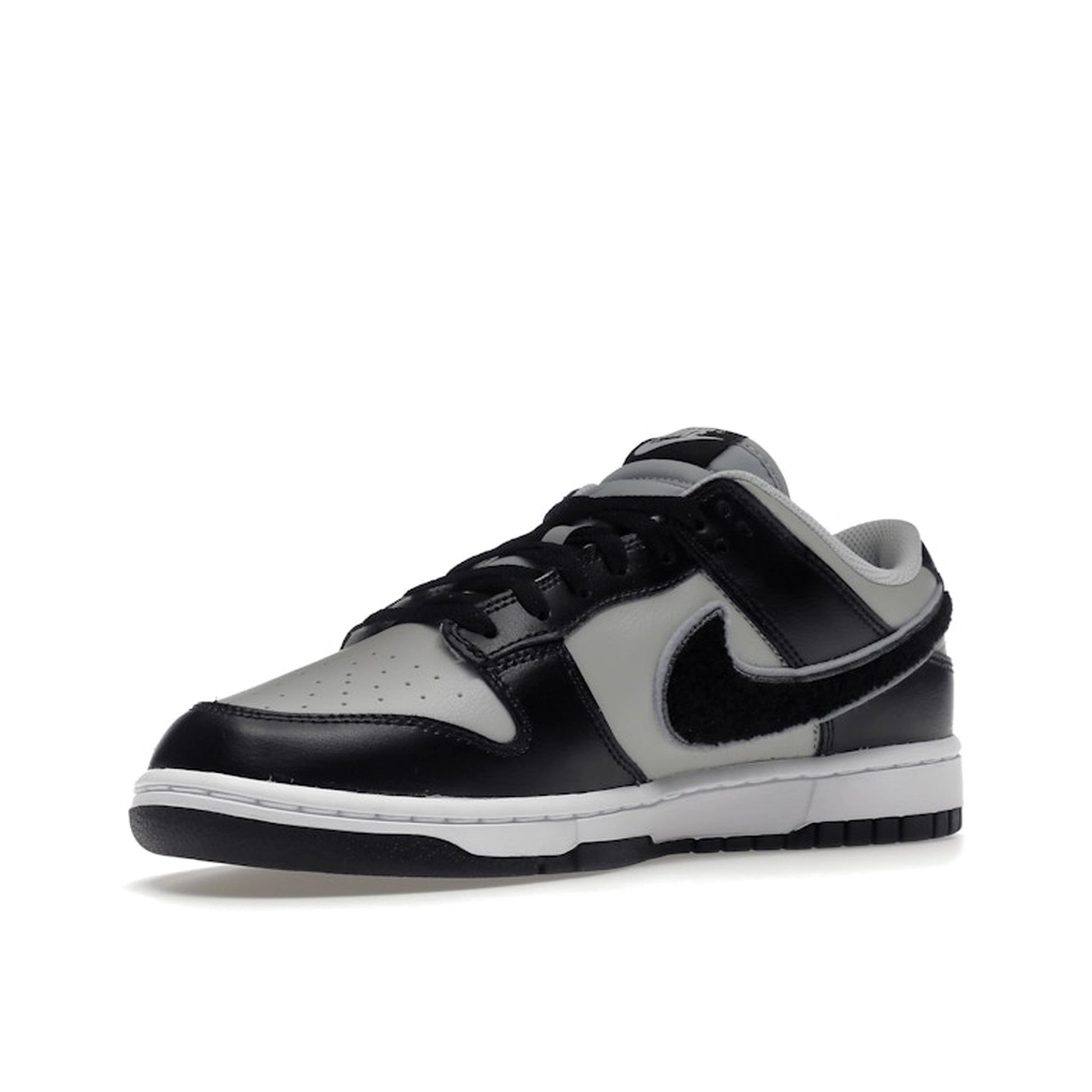 Nike Dunk Low Chenille Swoosh sneakers, front view, model DQ7683-001 in black and grey.