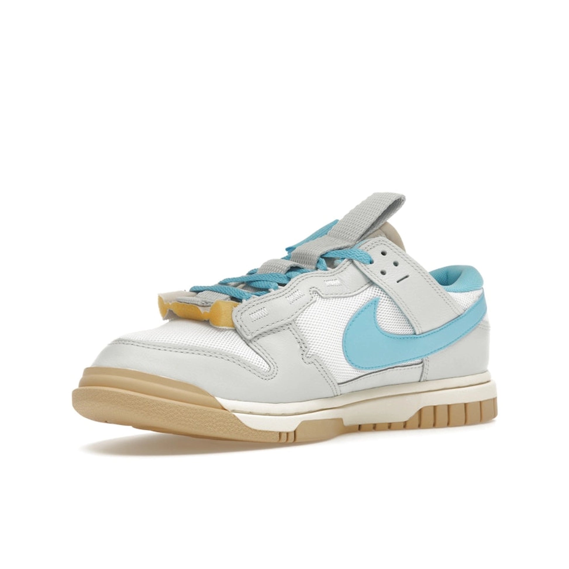Nike Dunk Low Jumbo Photon Dust, front view, with oversized Baltic Blue Swoosh and grey upper.