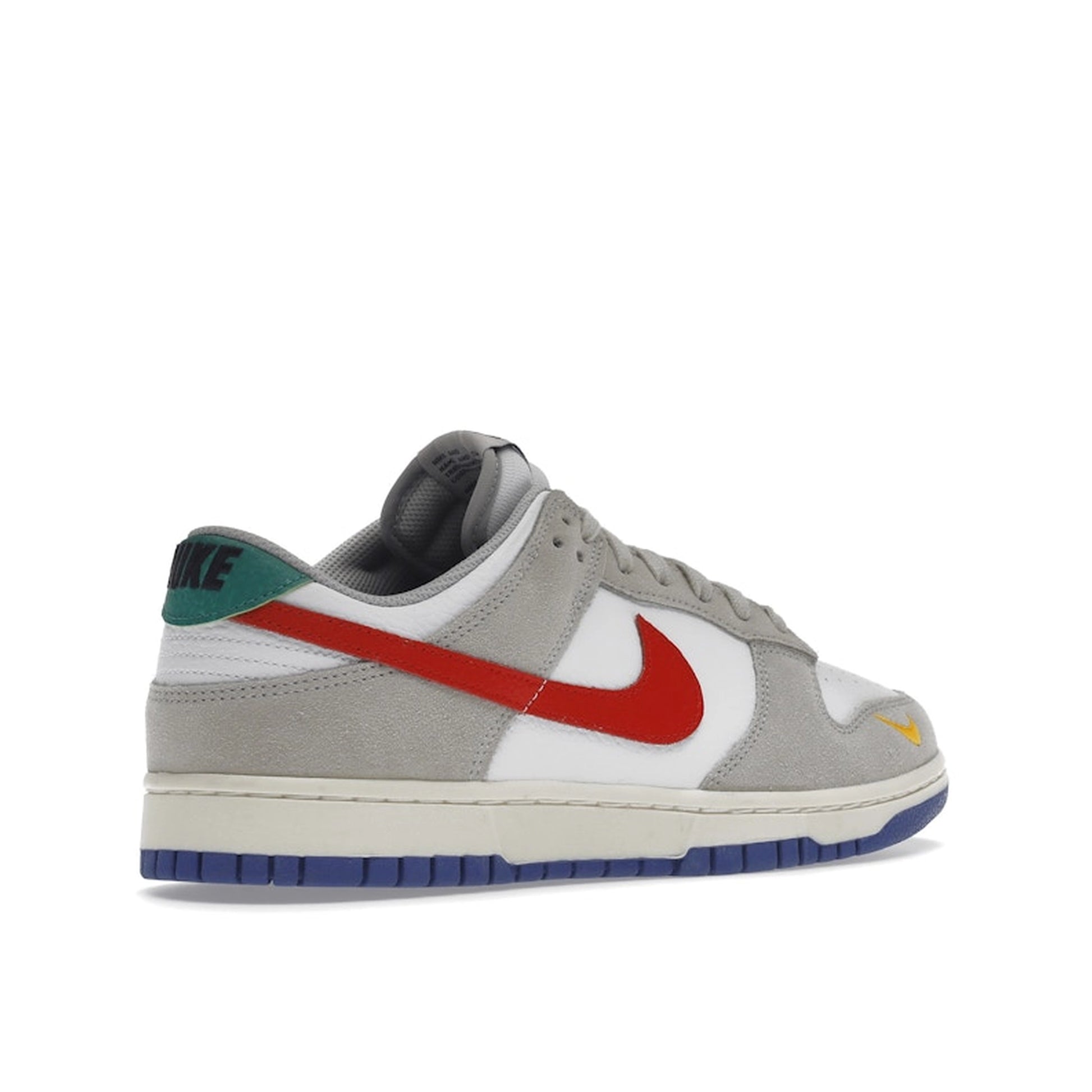 Nike Dunk Low sneakers, back view, model DV3497-001 in light iron ore with red and blue details.