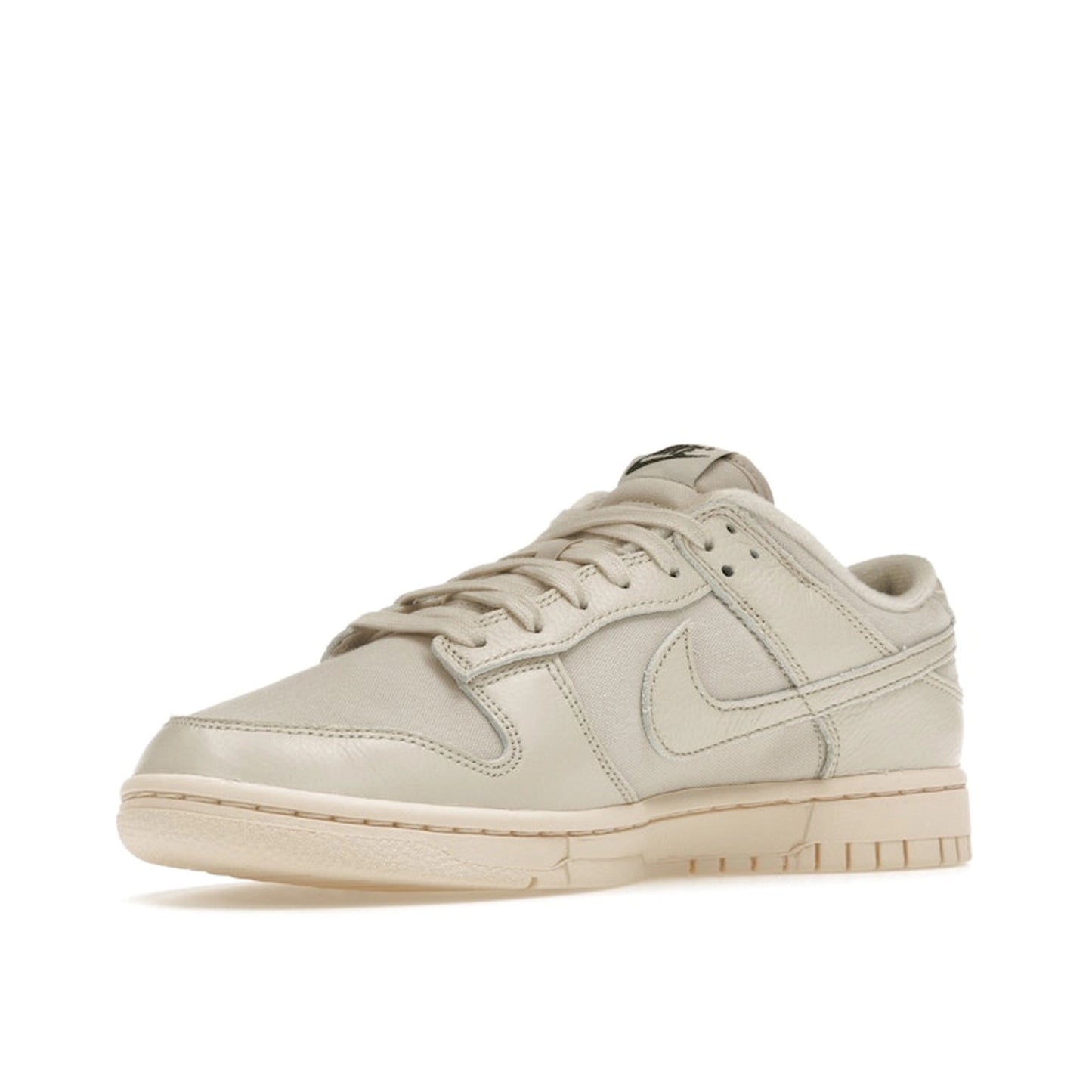 Nike Dunk Low Premium sneakers, front view, model DZ2538-100, in light orewood brown with white and beige accents.