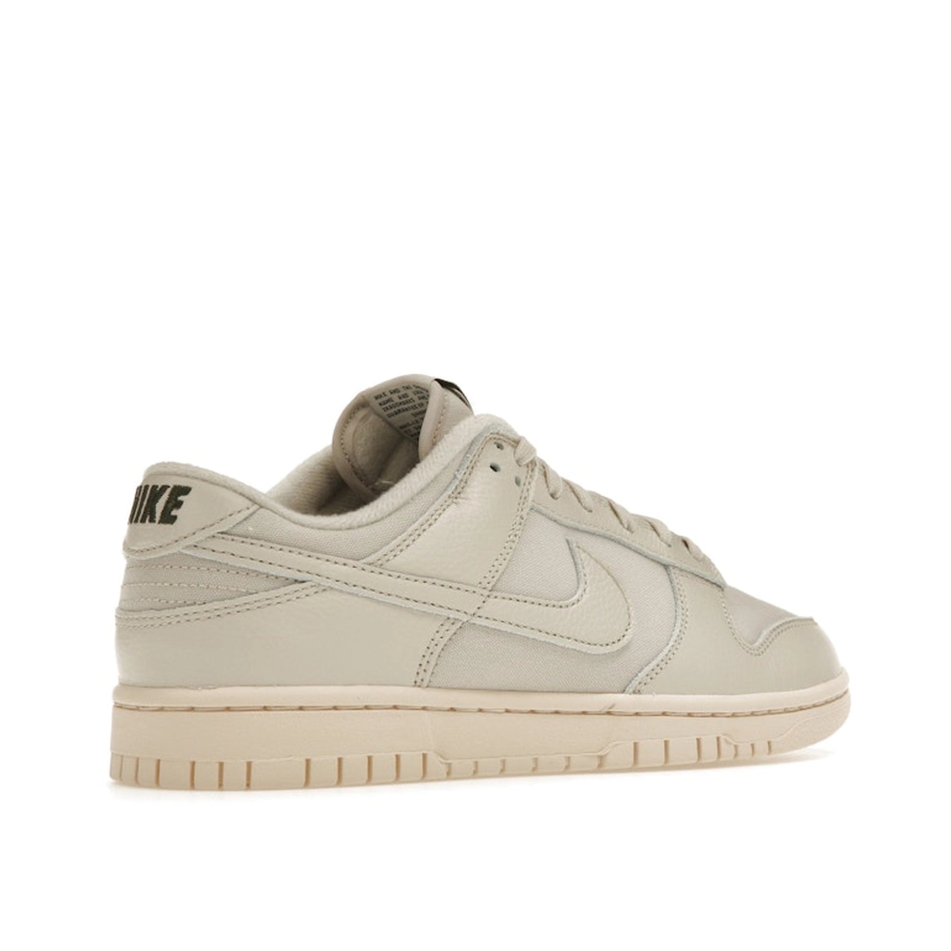 Nike Dunk Low Premium sneakers, back view, model DZ2538-100, in light orewood brown with white and beige accents.