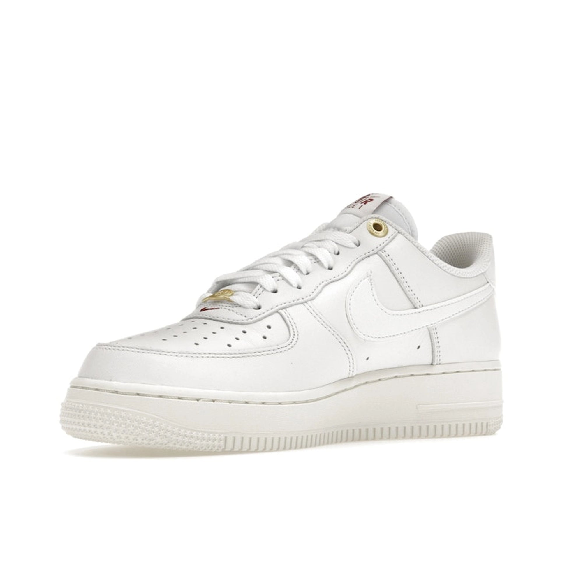 Nike Air Force 1 Low Premium, front view, in sail white with embossed Nike logo accents.