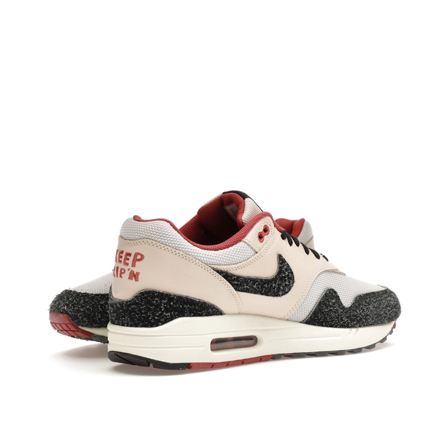 Nike Air Max 1 Keep Rippin Stop Slippin 2.0 sneakers, front view, model FD5743-200, black and beige with red accents.