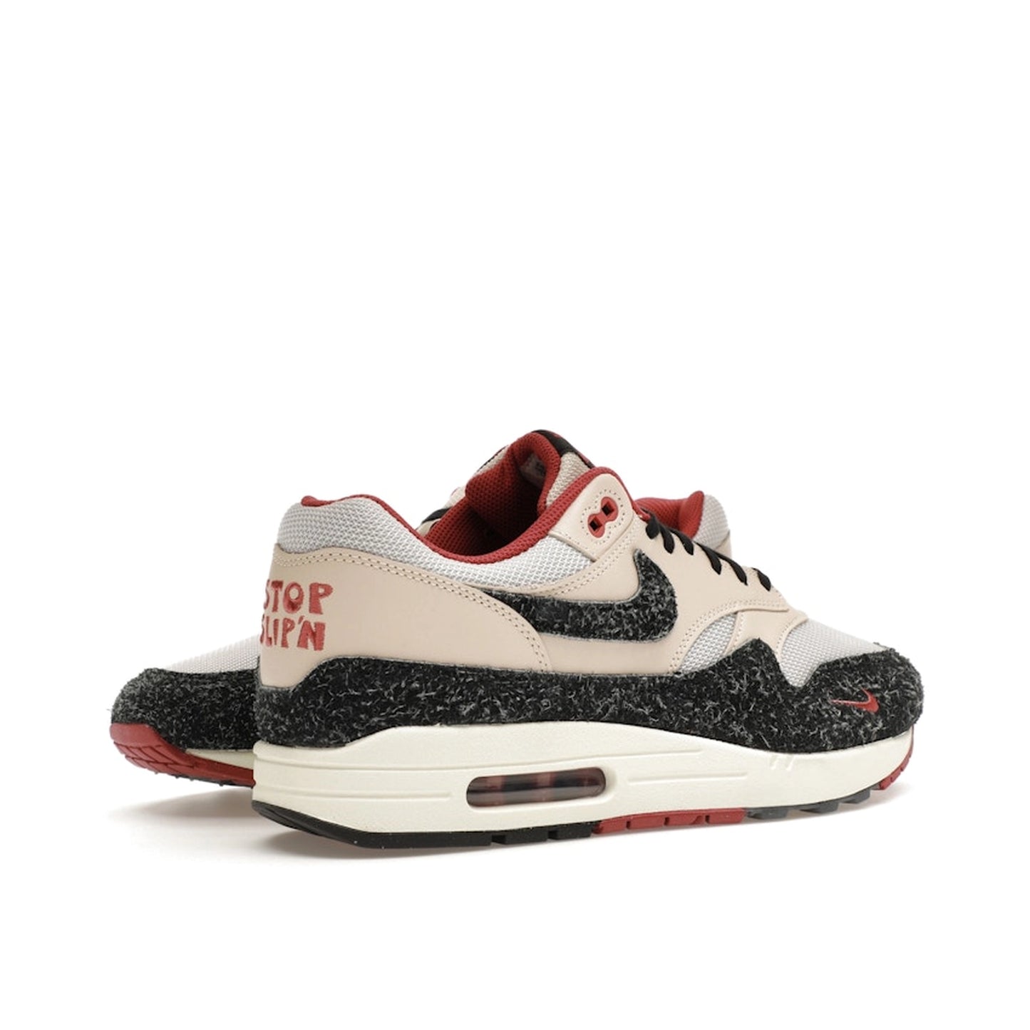 Nike Air Max 1 Keep Rippin Stop Slippin 2.0 sneakers, back view, model FD5743-200, black and beige with red accents.