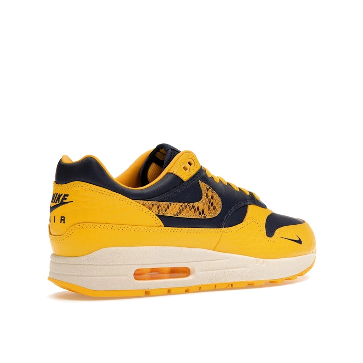 Nike Air Max 1 CO.JP Michigan Women’s sneakers, back view, in navy blue and maize yellow.