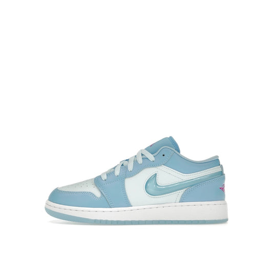 Jordan 1 Low SE sneakers (GS), side view, model FN7366-400, in Aquarius Blue with white details.