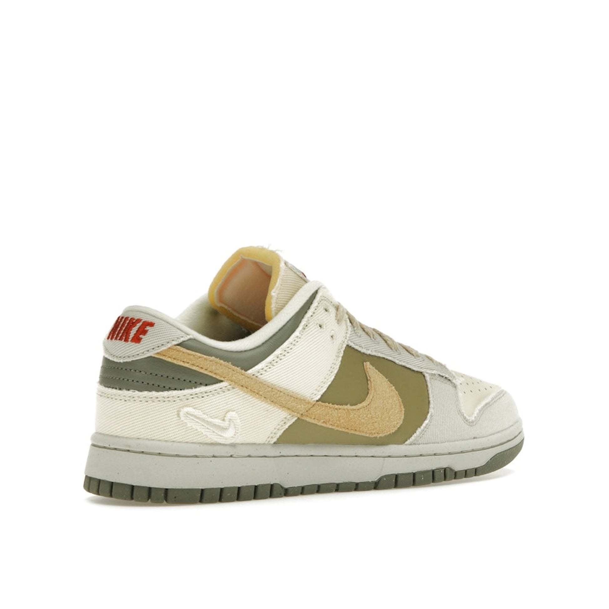 Nike Dunk Low Women's sneakers, back view, model FZ4341-100, in light bone with dark stucco and white accents.