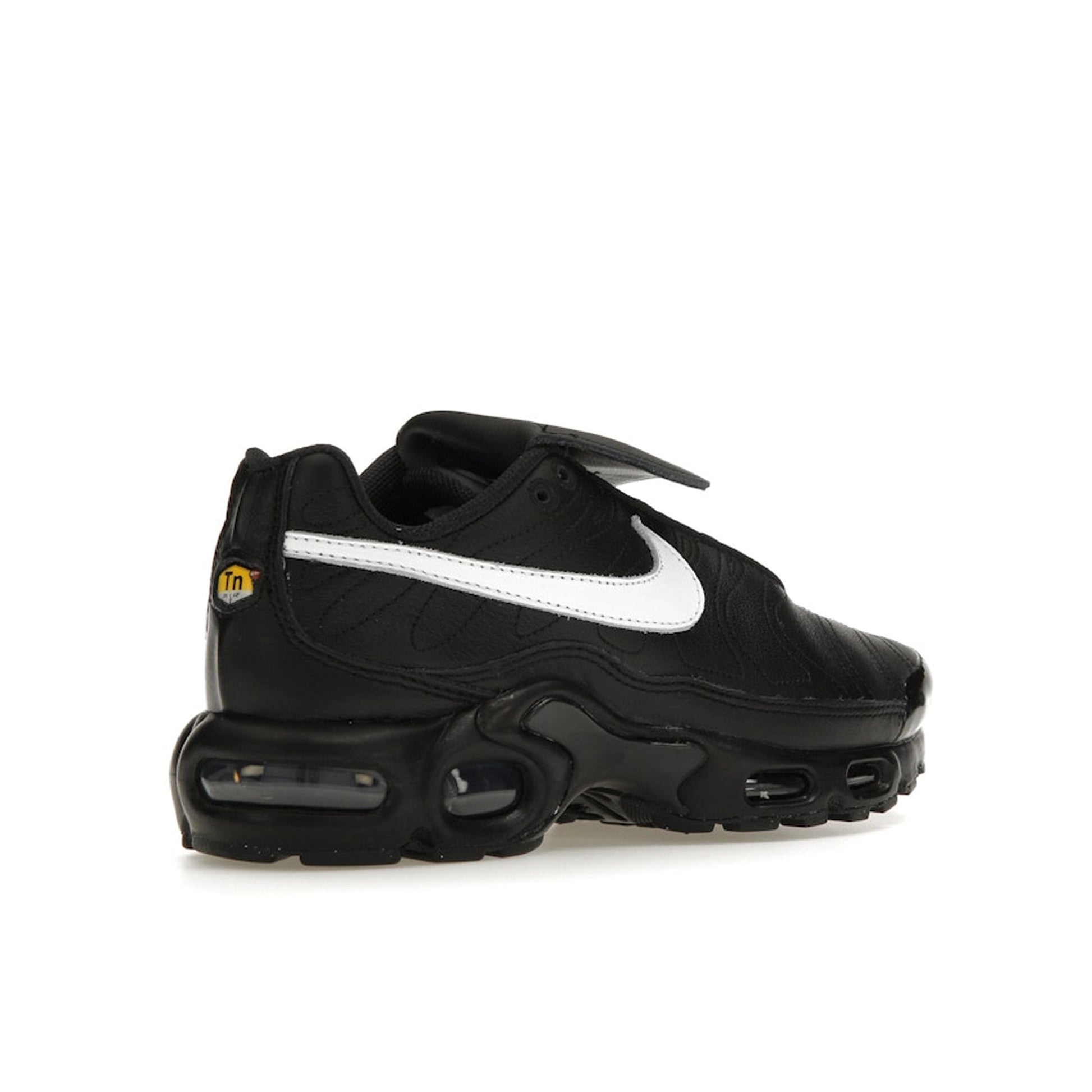 Nike Air Max Plus Tiempo, back view, in black leather with white swoosh and sole.