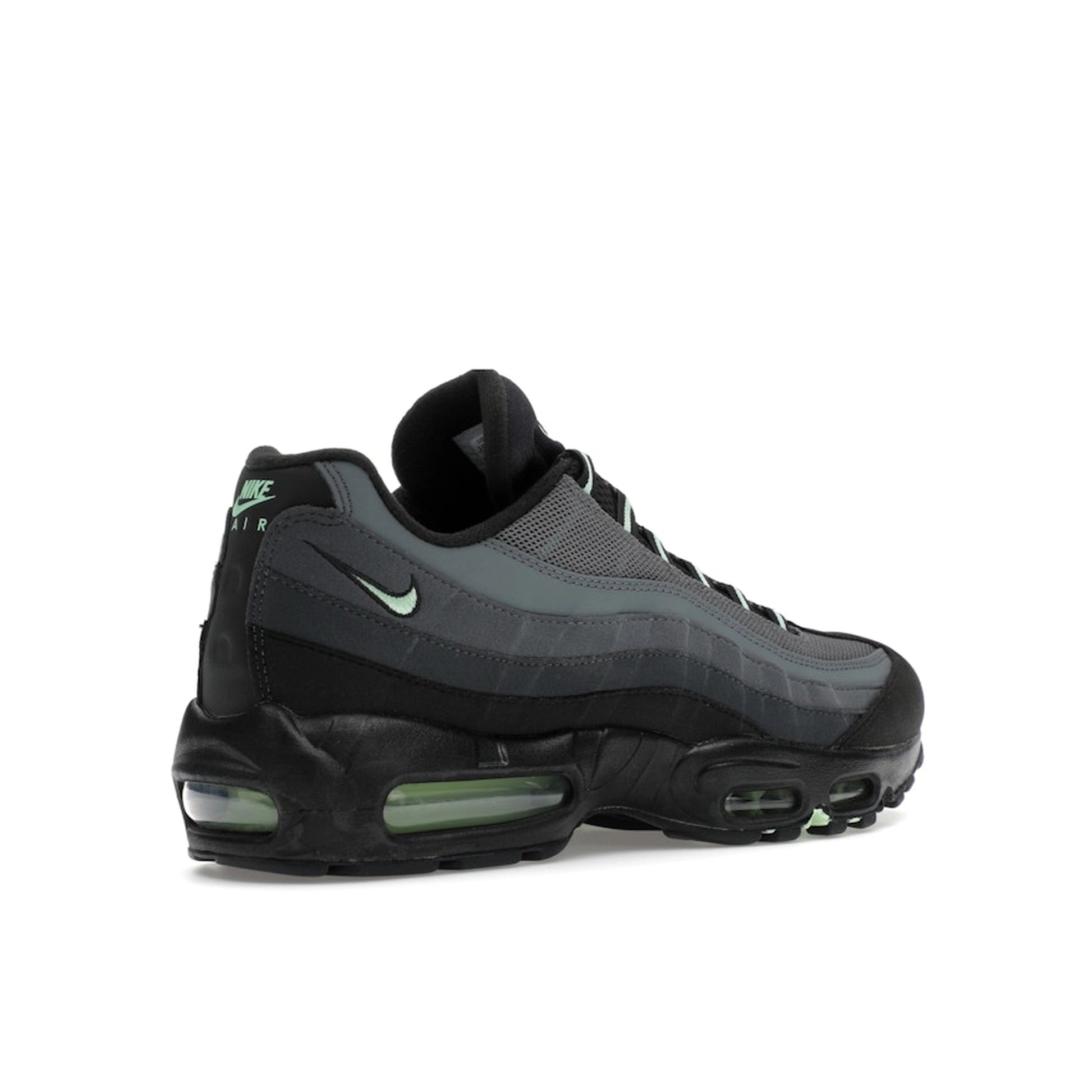 Nike Air Max 95 sneakers, back view, in black and grey with vapor green accents.