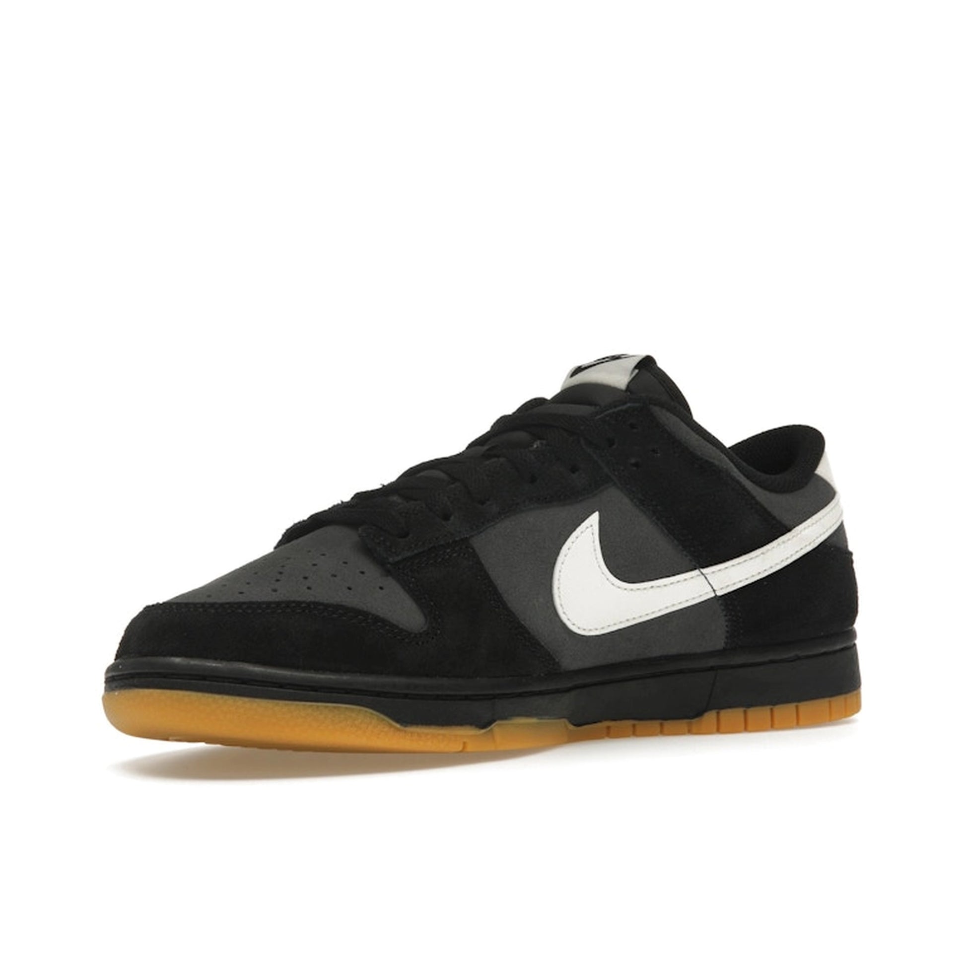 Nike Dunk Low SE, front view, in black and grey leather with gum sole.