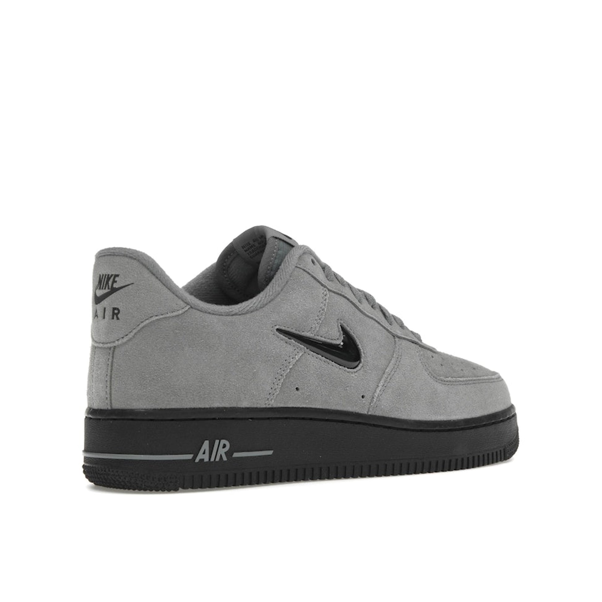 Nike Air Force 1 ’07 Low Jewel sneakers, back view, in cool grey with black swoosh.