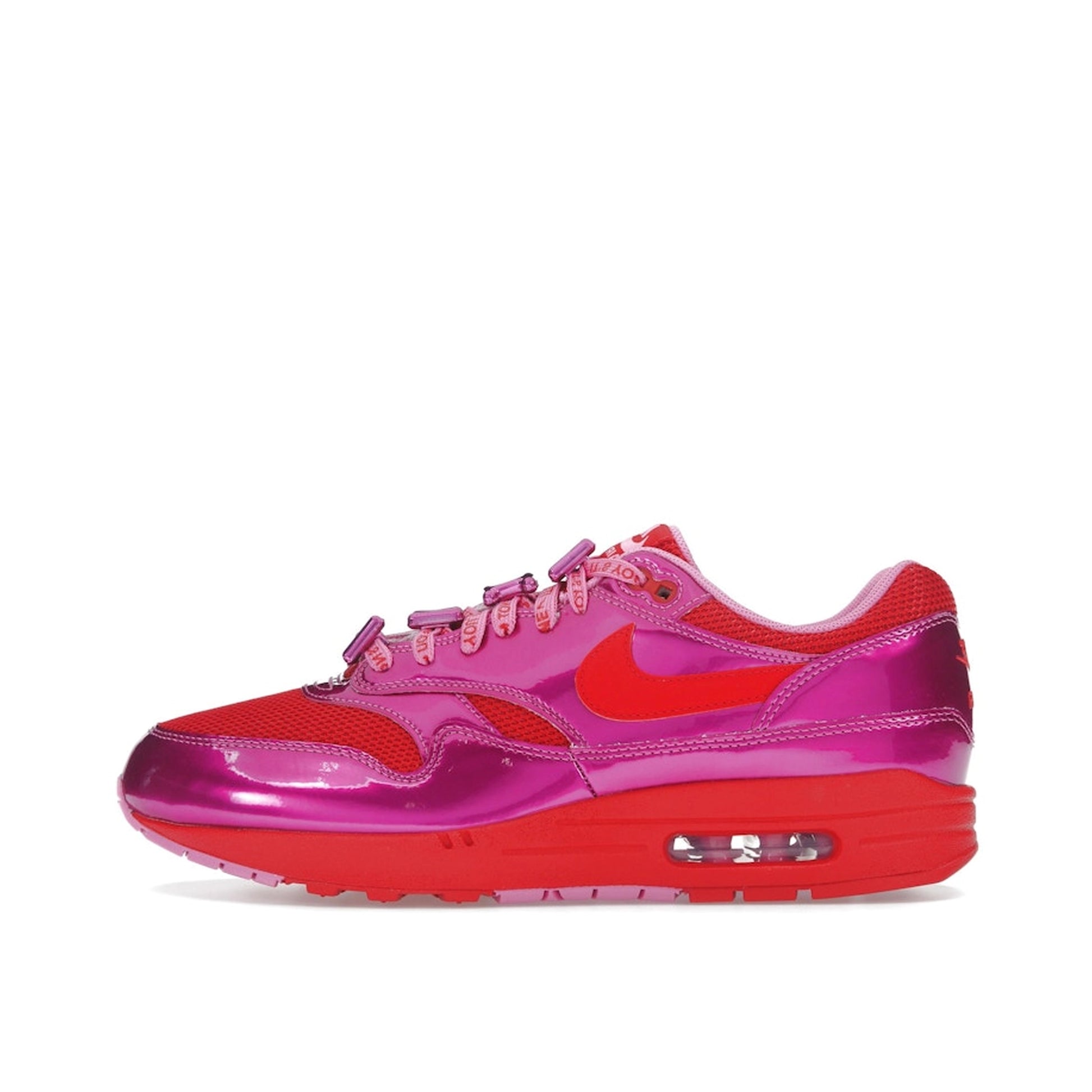 Nike Air Max 1 PRM sneakers, top view, in playful pink with white and heart-inspired accents.