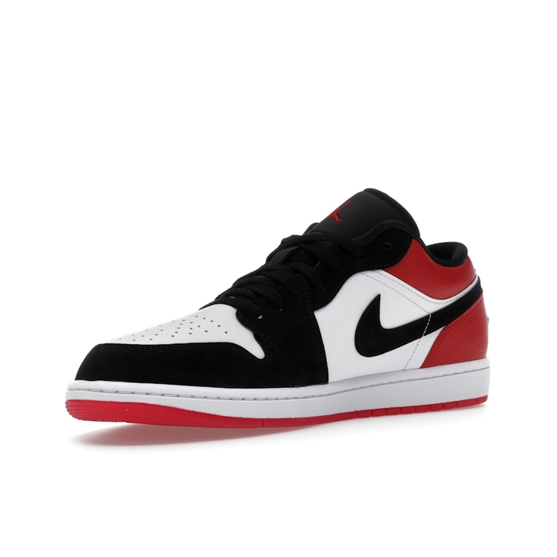 Jordan 1 Low SE Black Toe (2025), front view, in white leather with black toe box and red heel.