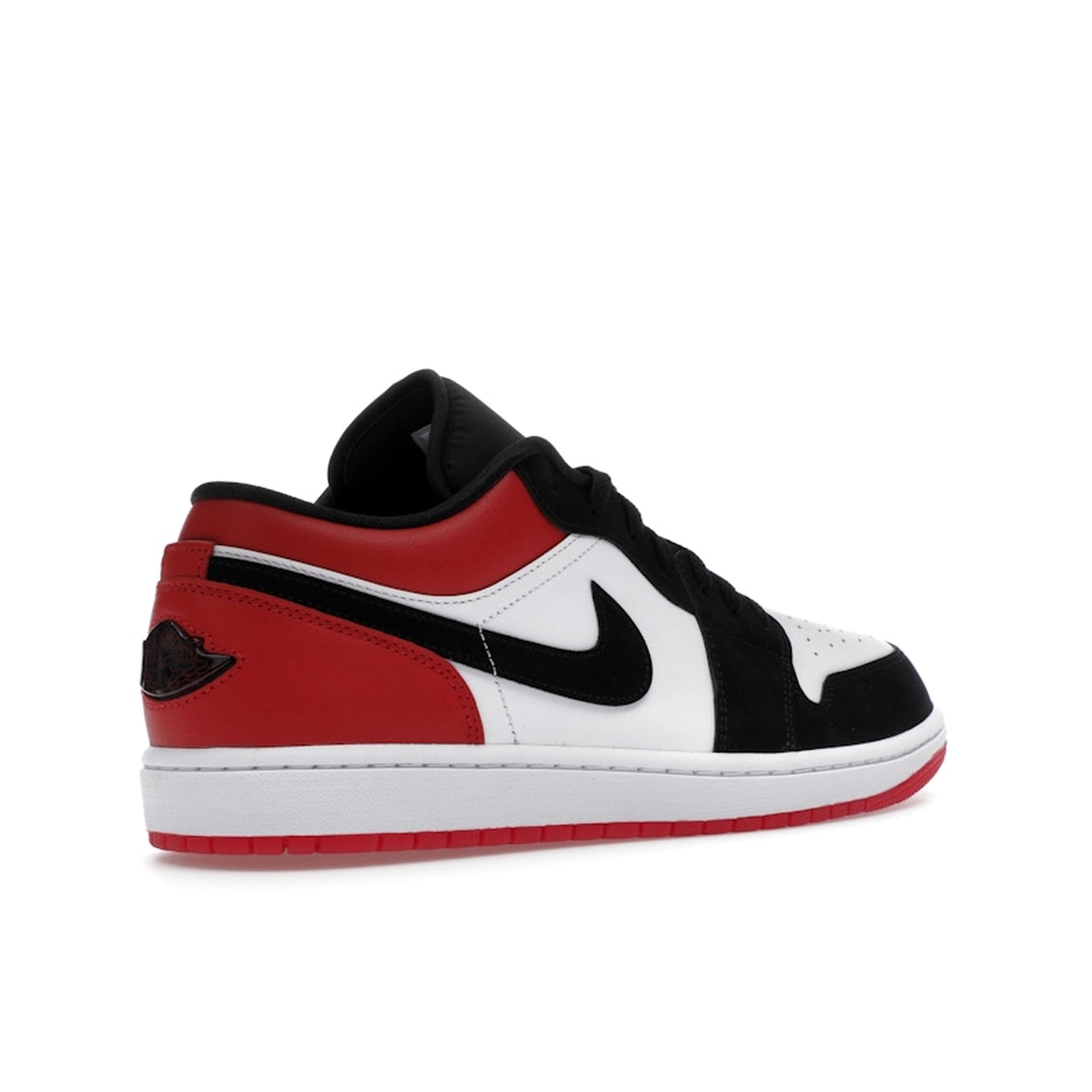 Jordan 1 Low SE Black Toe (2025), back view, in white leather with black toe box and red heel.