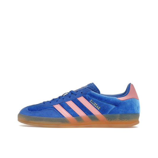 adidas Gazelle Indoor Women’s sneakers, side view, in blue with semi pink spark stripes and gum sole.