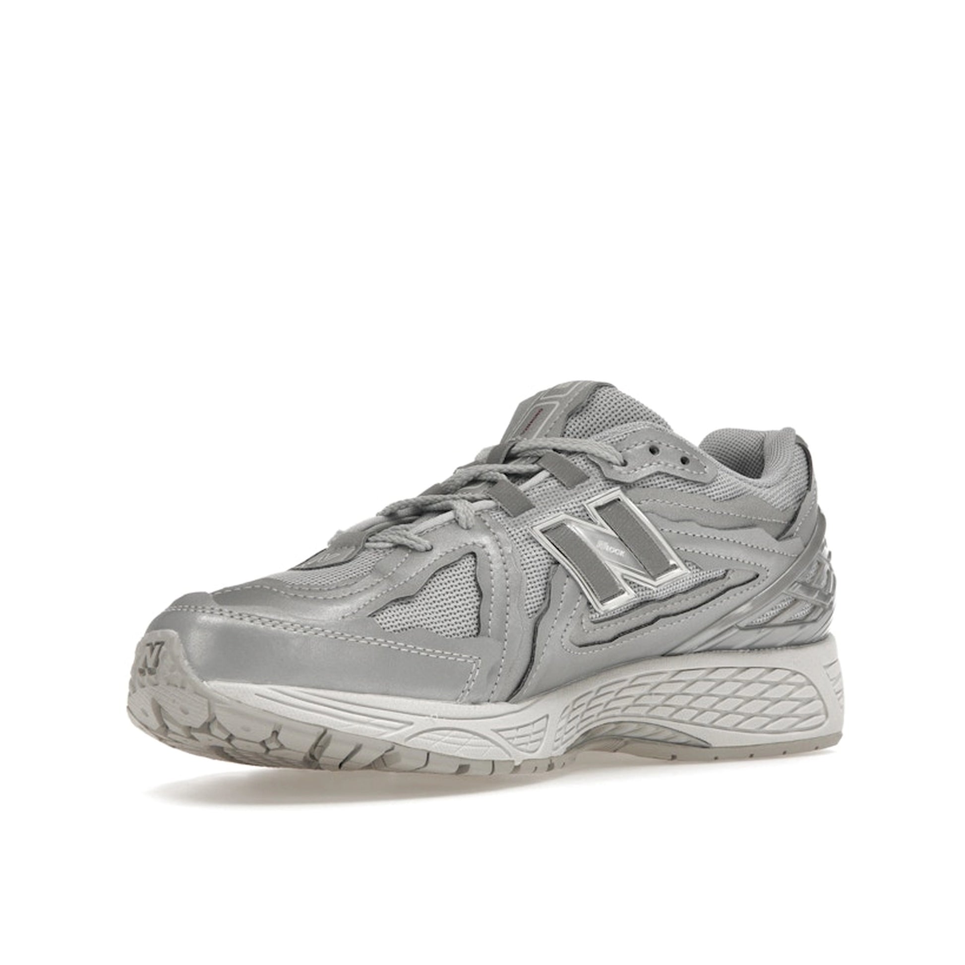 New Balance 1906D Protection Pack sneakers, front view, model M1906DH-1 in silver metallic with grey and white accents.