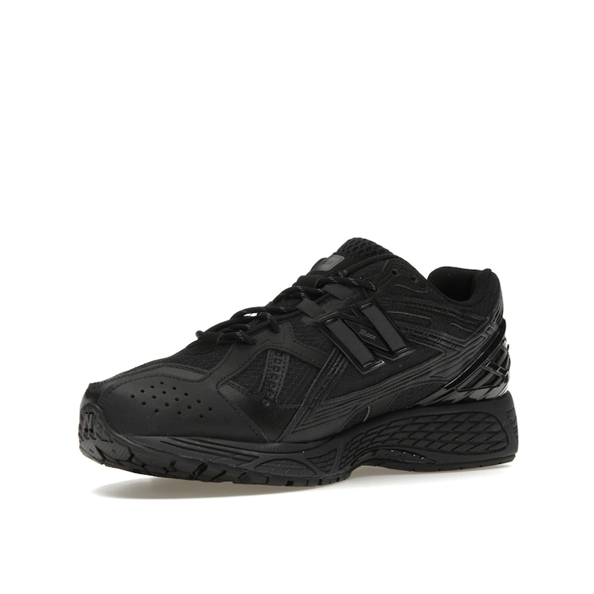 New Balance 1906U Triple Black sneakers, front view, in black with tonal elements.
