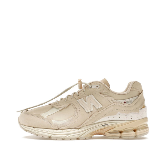 New Balance 2002R Protection Pack sneakers in Sandstone, side view, model M2002RDQ in beige.