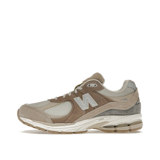 New Balance 2002R Driftwood Sandstone sneakers, side view, in beige and tan tones.