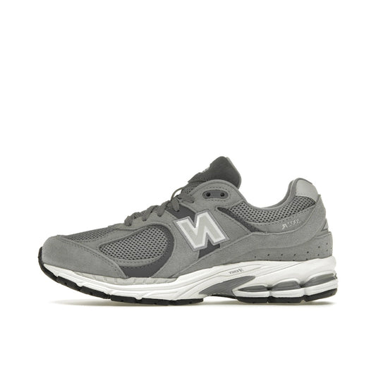 New Balance 2002R Steel Grey Orca, side view, in layered mesh and suede in grey and black.