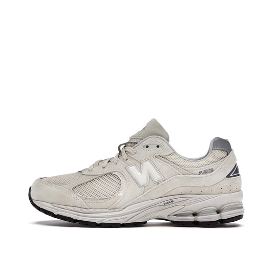 New Balance 2002R sneakers, side view, model ML2002RE, in bone with light aluminum accents.