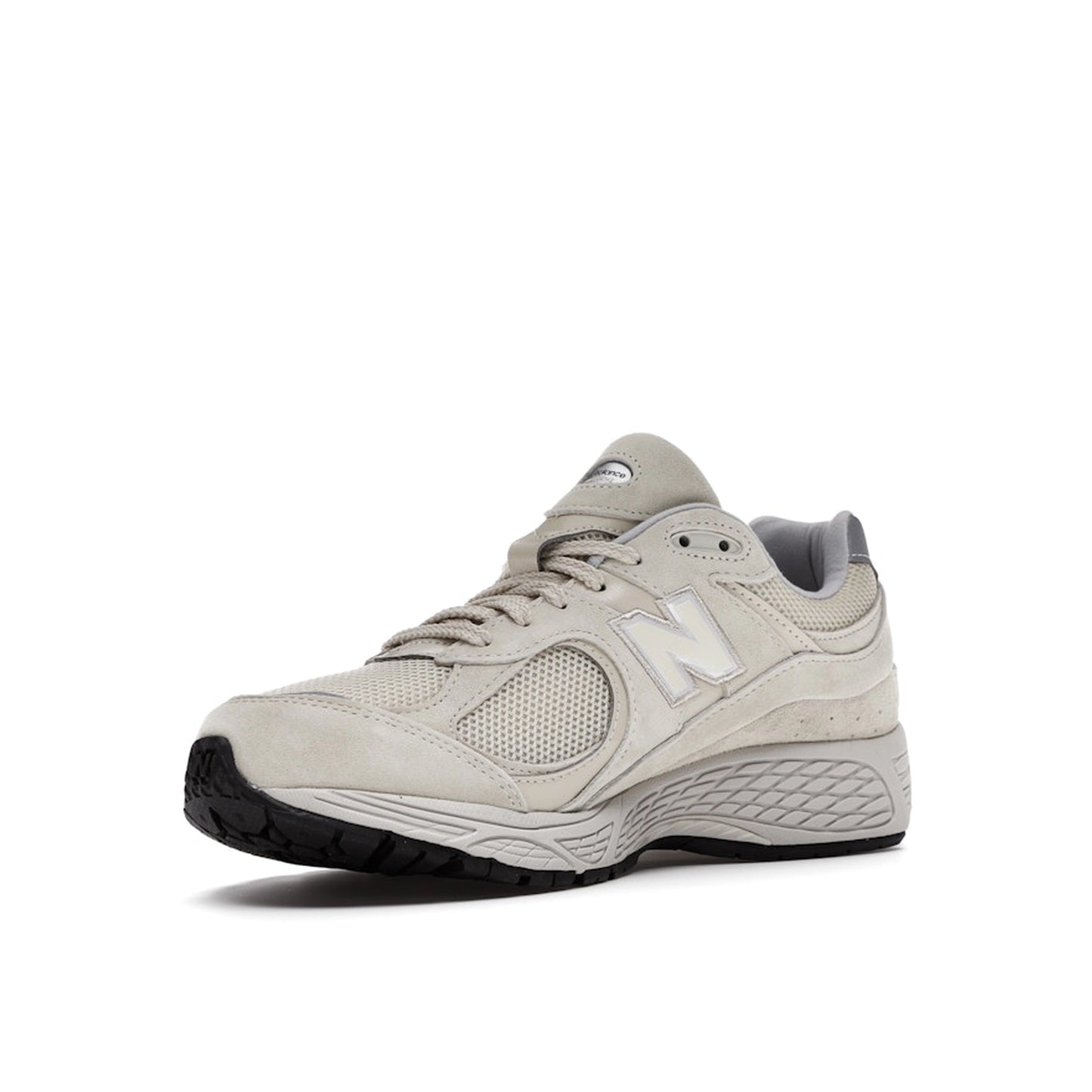 New Balance 2002R sneakers, front view, model ML2002RE, in bone with light aluminum accents.