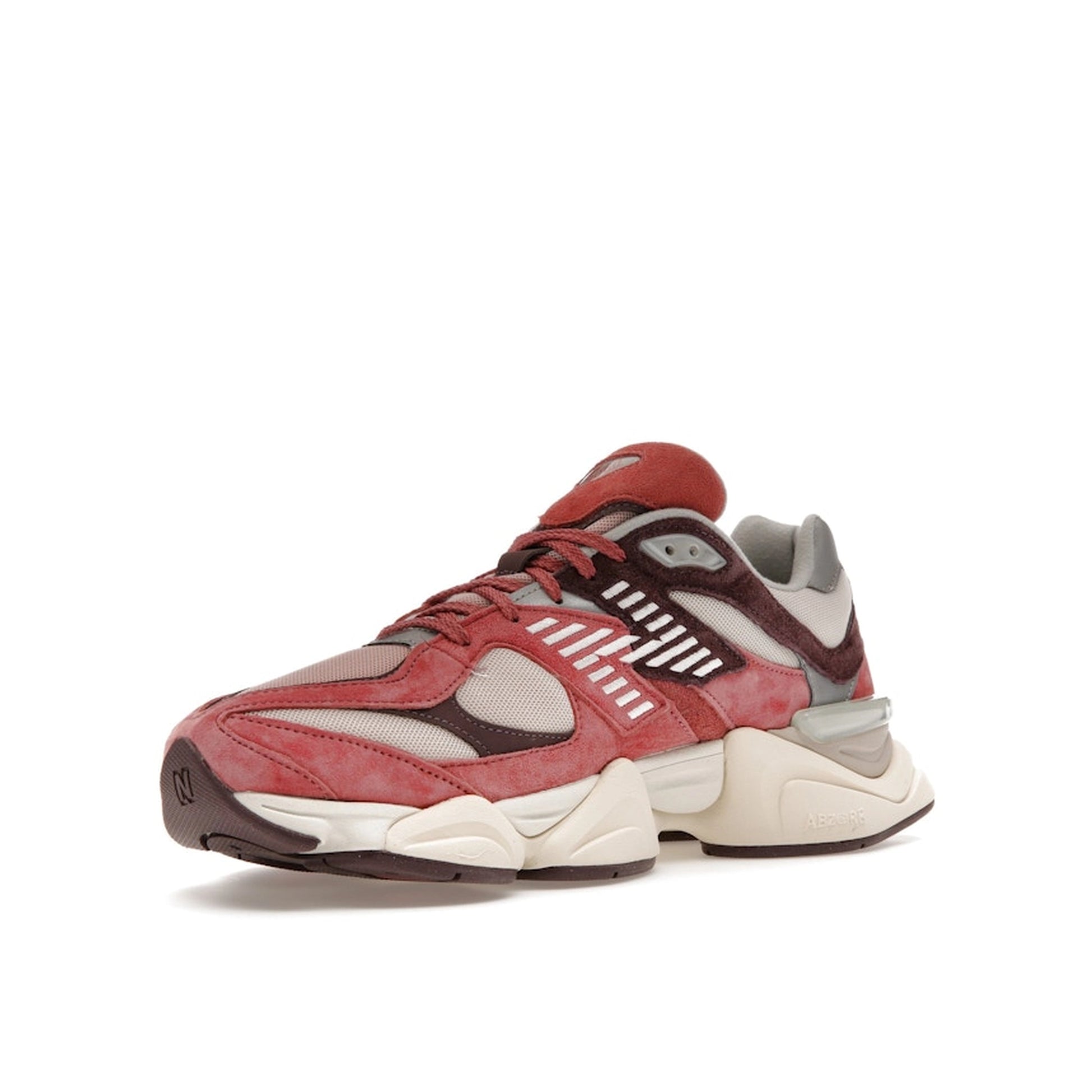 New Balance 9060 sneakers, front view, model U9060TRU in cherry blossom with beige and white details.